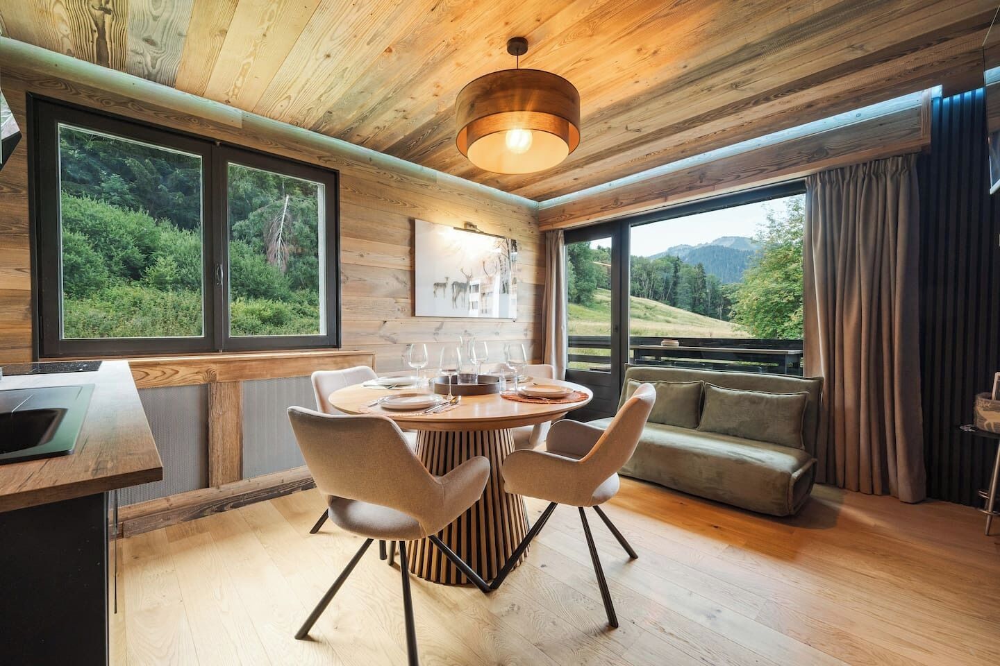 A dining area with a round table, chairs, and a view of the outdoors.