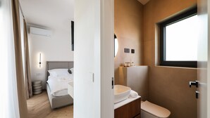 A modern hotel room with a bed, bedside table, and a bathroom with a toilet and sink. - Villa Anamaria Zadarvillas (Zadar)