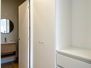 A bathroom with a white sink, mirror, and a closed white wardrobe. - w Airy 2BR w Balcony in Prime Miraflores (Lima)