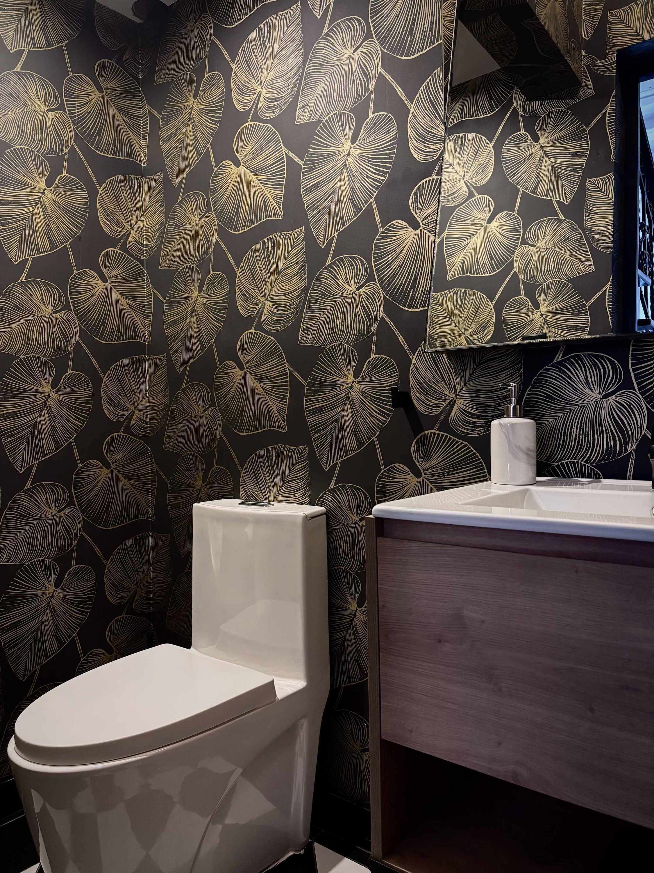 A modern bathroom with a toilet, a sink, and a mirror.