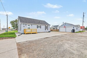 A residential area with a single-story house, a garage, and a small driveway.