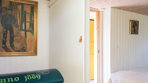A room with a bed, a painting, and a mailbox. - 4 Star Holiday Home in Juelsminde (Juelsminde)