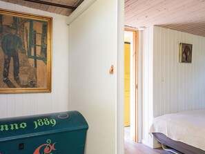A room with a bed, a painting, and a mailbox. - 4 Star Holiday Home in Juelsminde (Juelsminde)
