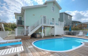 A two-story house with a pool and deck chairs. - Birdie Dunes | Private Pool | Walk to Beach | Holden Beach (Holden Beach)