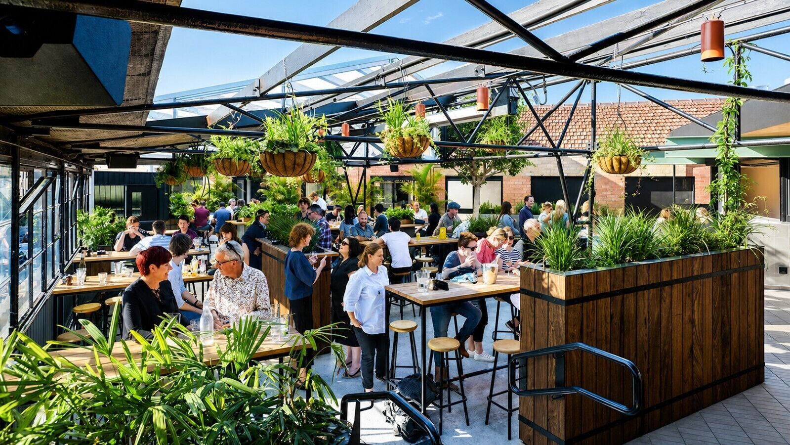 An outdoor dining area with multiple tables and chairs, surrounded by hanging planters and a wooden planter box.