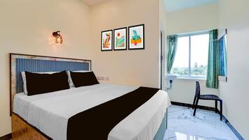 A bedroom with a bed, a wall-mounted light, and a window with curtains.