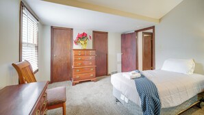 A bedroom with a bed, a wooden dresser, a chair, and a window with blinds. - 6 Mi to Dtwn! Historic Haven in Cleveland (Cleveland)