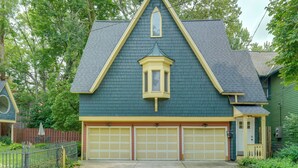 A two-story house with a gabled roof, a bay window, and a garage with two doors. - 6 Mi to Dtwn! Historic Haven in Cleveland (Cleveland)