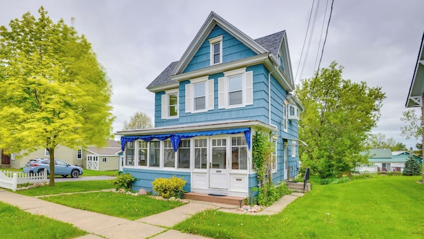 A two-story house with a blue exterior, a covered front porch, and a well-maintained lawn. - Walk to Dtwn Clayton & River! 2-unit Getaway (Clayton)