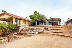 Zona residencial amb una casa que té teulada d'àmples lloses i un porxo cobert.