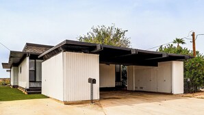 A two-story building with a covered garage and a small front yard. - Colorado River Family Escape in Bullhead City (Bullhead City)