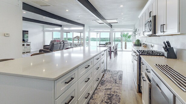 A modern kitchen with a large island, built-in appliances, and a view to the outdoors. - Colorado River Family Escape in Bullhead City (Bullhead City)