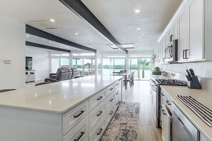 A modern kitchen with a large island, built-in appliances, and a view to the outdoors. - Colorado River Family Escape in Bullhead City (Bullhead City)
