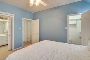 A bedroom with a large bed, a wardrobe, and a door leading to another room. - Spacious Backyard & Patio! Family Haven in Odessa (Odessa)