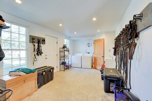 A laundry area with a washing machine, dryer, and various hanging items. - 5-unit Retreat Near World Equestrian Center & Hits (Morriston)