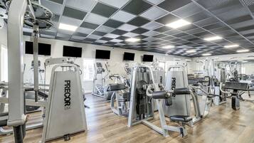 A gym with various exercise machines, including weight benches and cardio equipment.