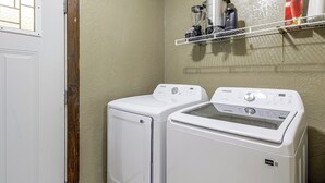 A laundry area with two white front-loading washers and a stainless steel coffee maker on a shelf. - Centrally Located Nature Escape in Trenton (Trenton)