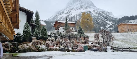 A snow-covered mountain with buildings in the foreground.