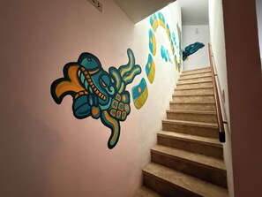 A staircase with a wall mural featuring abstract designs. - Casa Villa Leo, Downtown Cancún (Cancún)
