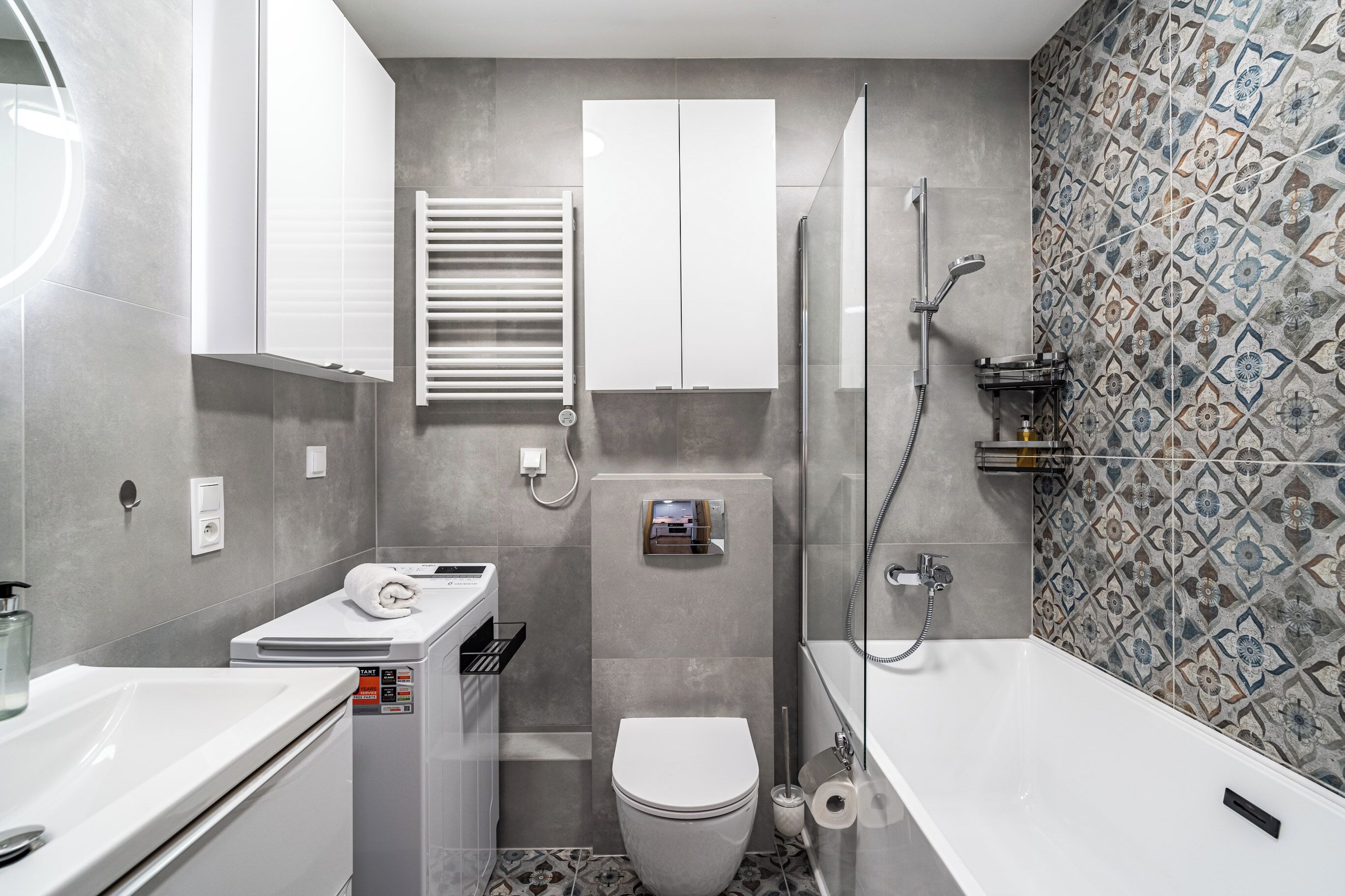 A modern bathroom with a toilet, bidet, and shower.