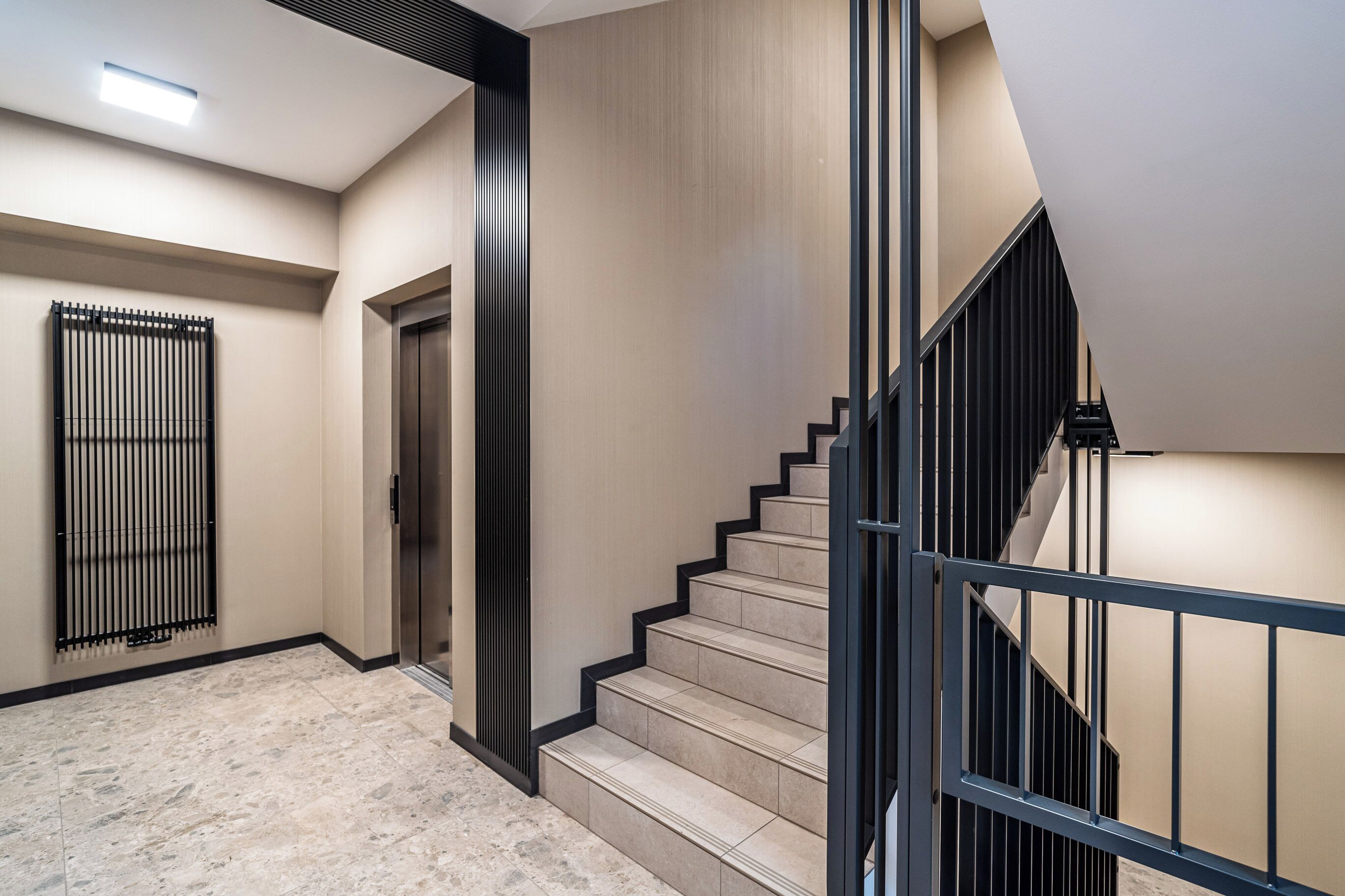 A modern interior with a staircase, a door, and a vent.