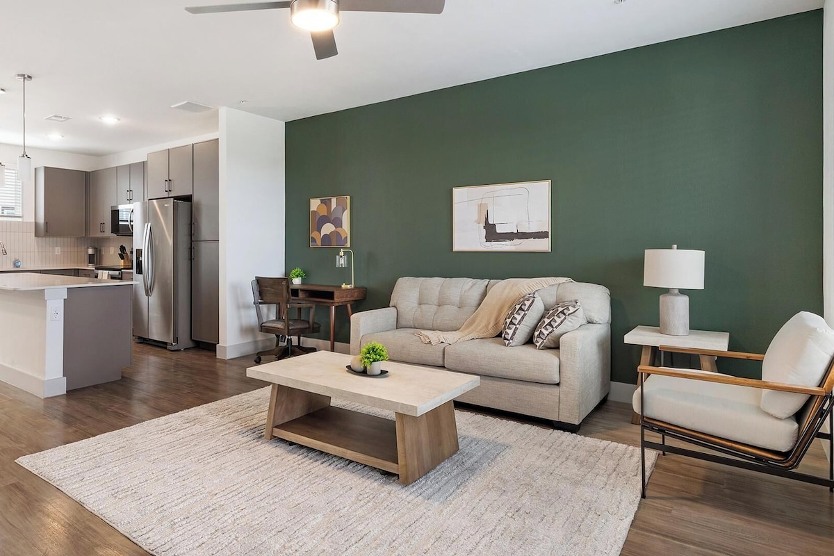 A modern apartment with a kitchen, living room, and dining area.