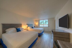 A hotel room with two beds, a desk, and a TV. - 2 Beachside Rooms with Onsite Pool Access | Steps to Willy's Adventure Zone (Fort Walton Beach)