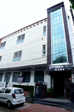 A multi-story building with a sign for 'MVD Stay' on the ground floor.