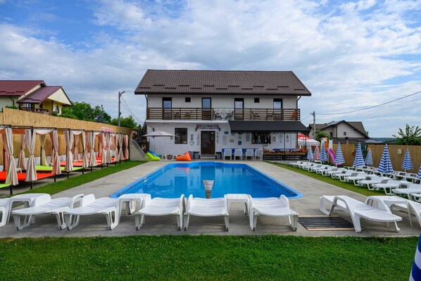 Seasonal outdoor pool, pool umbrellas, pool loungers