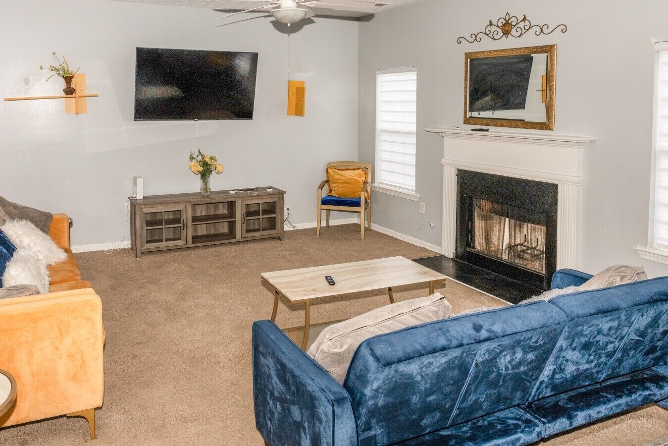 A living room with a fireplace, a television, and a sofa.