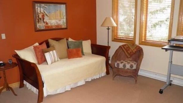 A room with a sofa, a chair, a lamp, and a window with blinds. - Strawberry Park Condos With Easy Ski-in Ski-out Access Steps Away From Center Of Beaver Creek Village 1 Bedroom Condo (Avon)