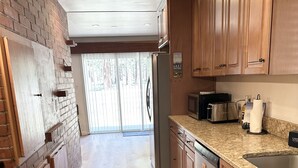 A kitchen with wooden cabinets, a stainless steel refrigerator, a microwave, and a dishwasher. - Hch0681 - Red Lake Lodge 3 Bedroom Home (South Lake Tahoe)
