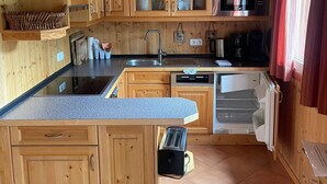 Keittiössä on puukehikoiset kaapit, sisäänrakennettu mikroaaltouuni ja kahvinkeitin.