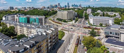 A cityscape with modern buildings, a busy intersection, and a clear sky.