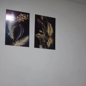 Two wall-mounted artworks depicting celestial and botanical themes.