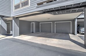 A garage with two doors, a covered driveway, and a vehicle parked inside. - Updated Animas Valley Condo with Awesome Views - 2 Decks (Durango)