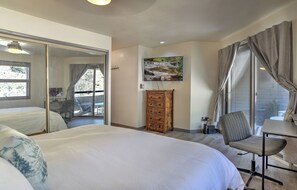A bedroom with a large bed, a dresser, a chair, a desk, and a television. - Updated Animas Valley Condo with Awesome Views - 2 Decks (Durango)
