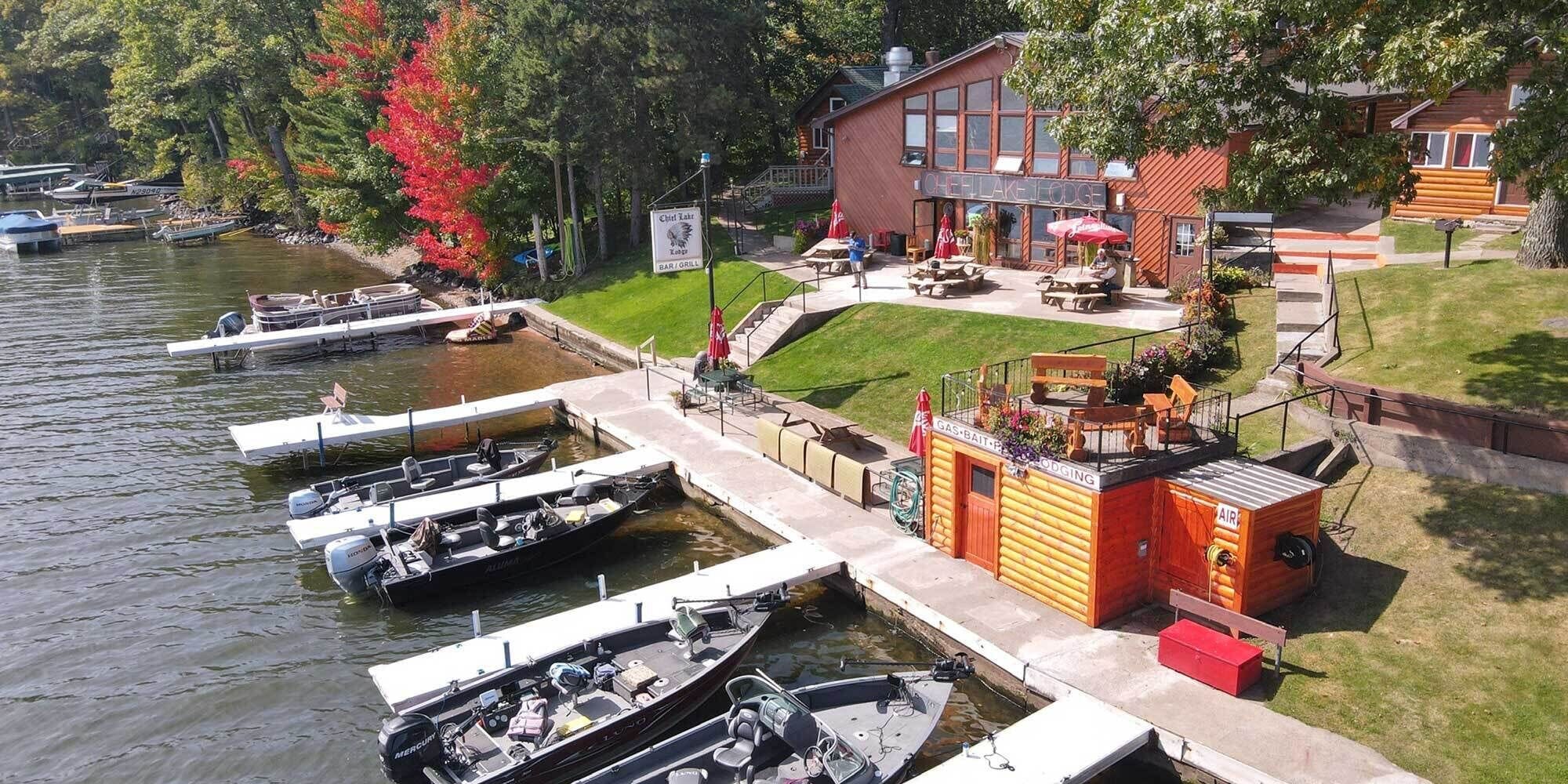A lakeside lodge with docked boats, a bar, and a restaurant.