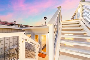 A multi-level building with a staircase, a balcony, and a view of the sky. - 25% Off Nov 5-8, Walk To Beach, Roof-Top Patio! (Oxnard)