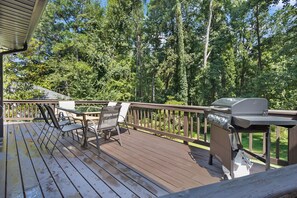 A wooden deck with outdoor furniture and a grill. - Buckhead Hideaway ~ 4BR, Fire Pit, Big Deck! (Atlanta)