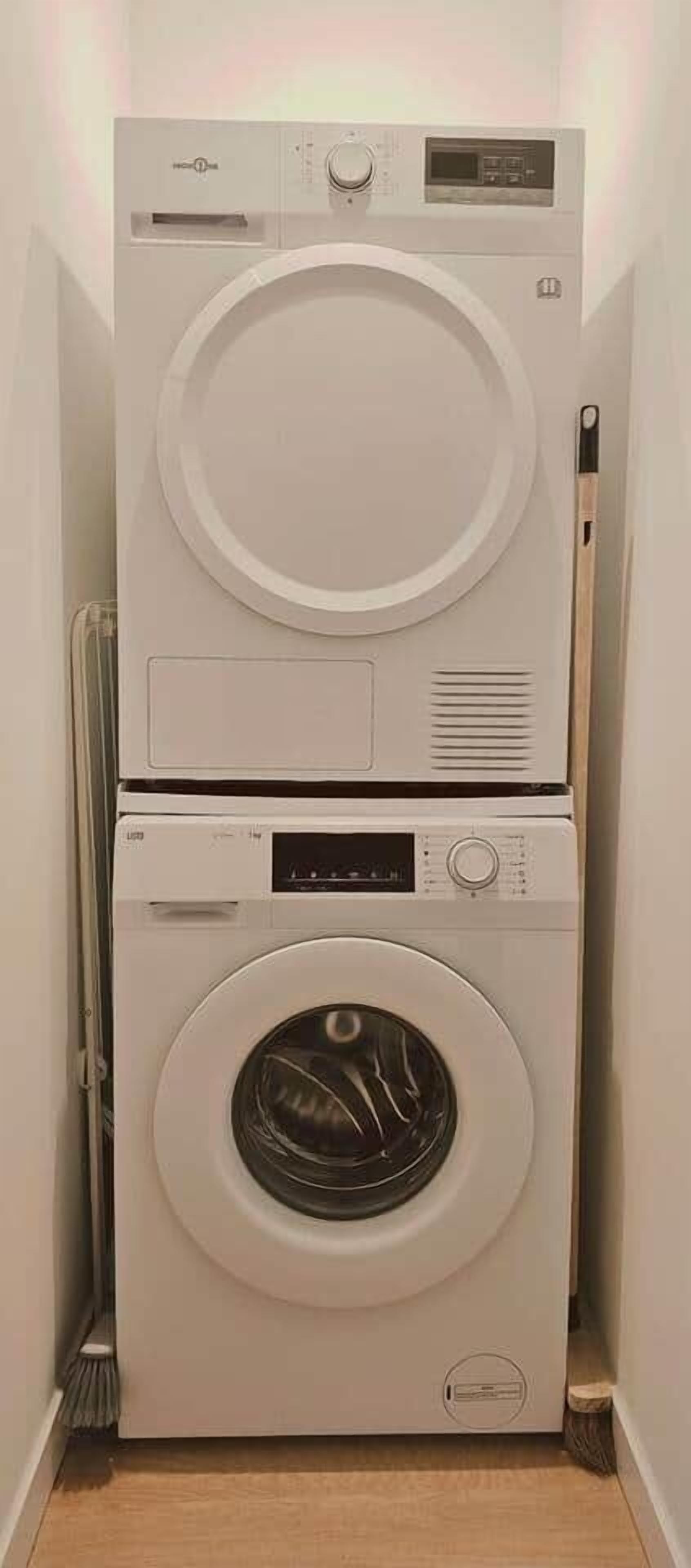 A compact, wall-mounted washer and dryer unit in a narrow hallway.