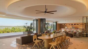 A modern interior with a dining area, sofas, and a bar.