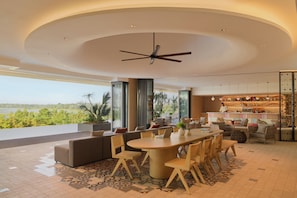 A modern interior with a dining area, sofas, and a bar. - Asai Gamuda Cove (Banting)