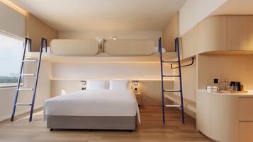 A modern bedroom with a bunk bed, a desk, and a view of the city.