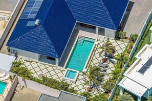 A residential property with a swimming pool, solar panels, and a garden area. - NEW 3BR Luxe Villa in Esmeralda by Signature Stays (Noord)