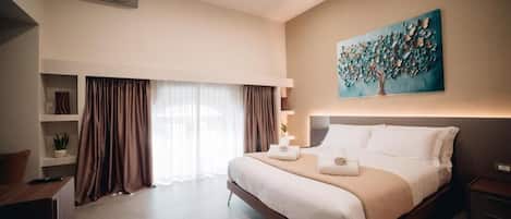 A hotel room with a large bed, a painting on the wall, and a window with curtains.