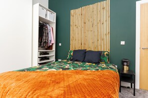 A bedroom with a bed, a wardrobe, and a bedside table. - Near Cavern Club 2-storey Westminster (Liverpool)