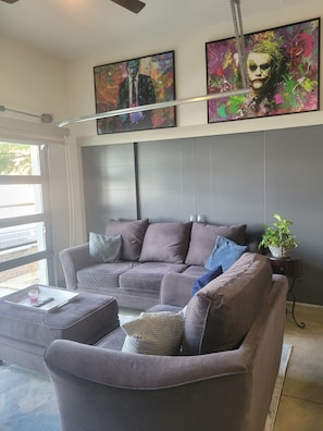 A modern living room with a sectional sofa, a coffee table, and a potted plant. - Delightful 2-bedroom apartment with AC in vibrant Downtown Dallas entertainment (Dallas)