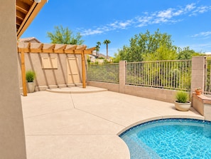 A backyard with a swimming pool, a pergola, and a fenced area with plants. - Mayo wellness retreat Pool, sauna + red light (Scottsdale)
