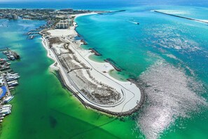 An aerial view of a coastal area with a marina, sandy beach, and clear blue waters. - 🌴Gulf Front~Pools~Onsite Restaurant~Balcony~Sauna~1BR SunDestin 1405🌴 (Destin)